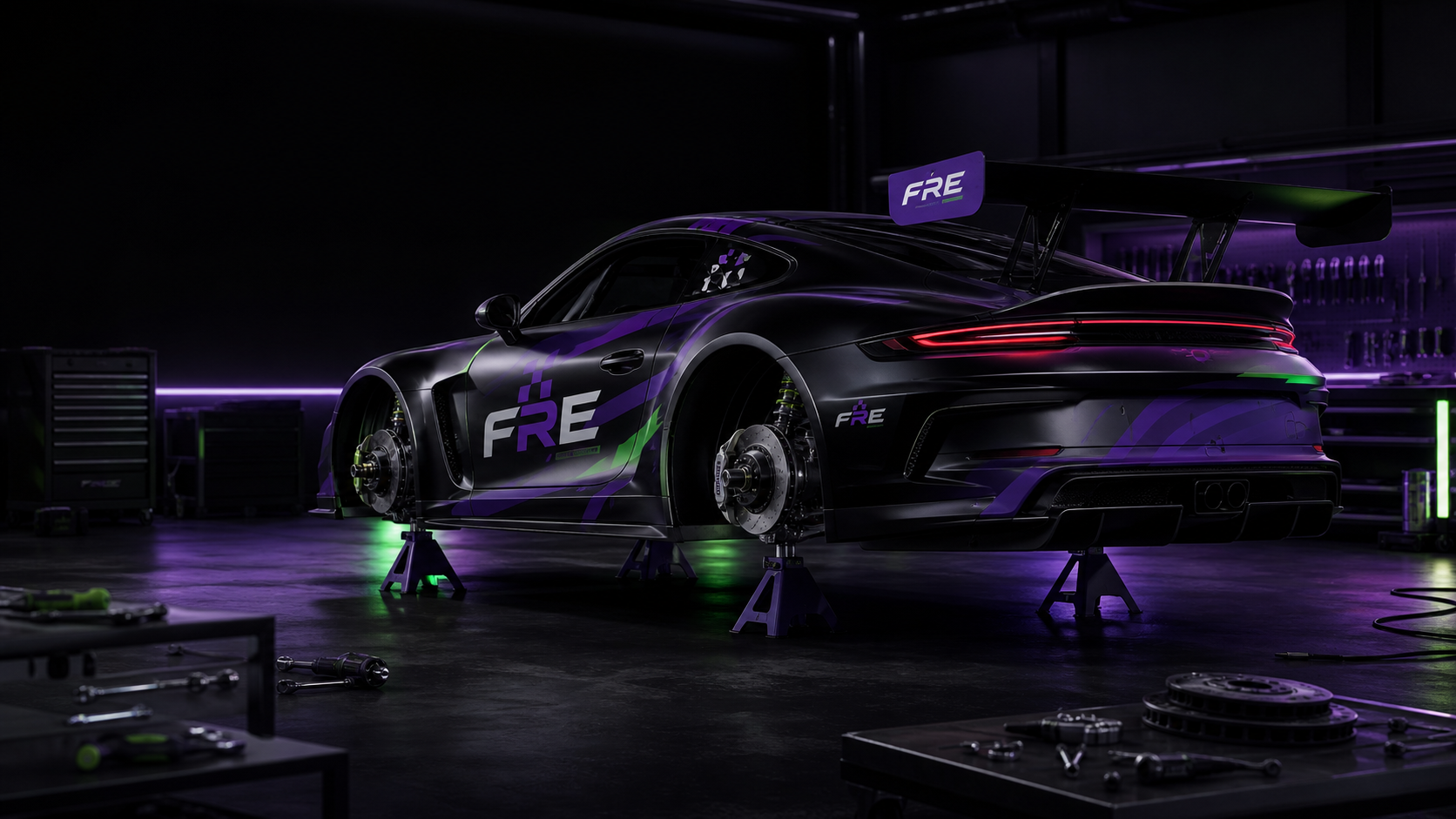 FRE stock car on stands with wheels removed and brake discs visible, representing a module under development
